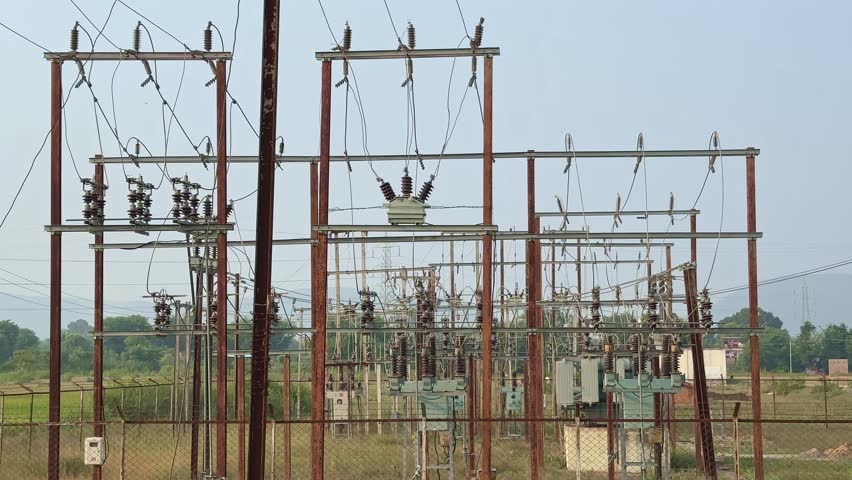 Tilt up shot of a electricity power station in India, Electrical substation with various transformers and Ceramic or Porcelain Post Insulator are being used