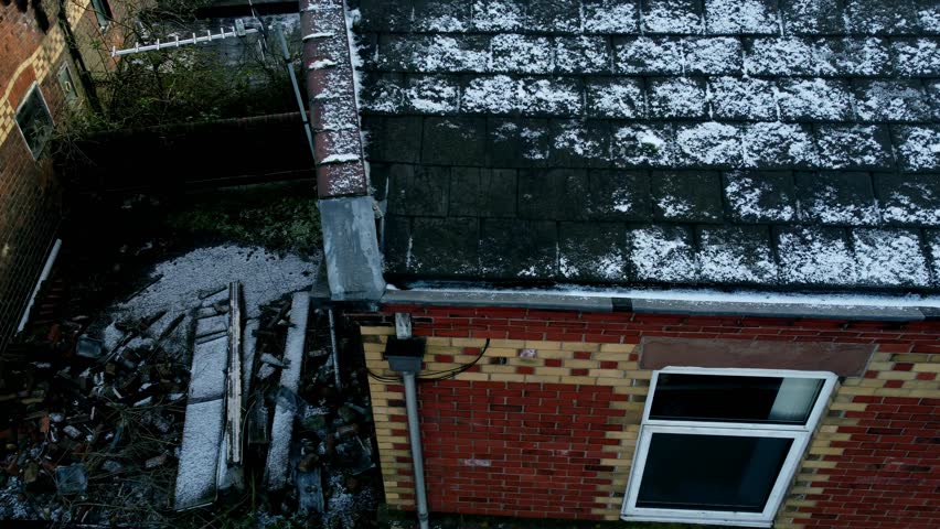 Aerial view establishing snowy old 1894 brickwork town house on bright sunny winter morning