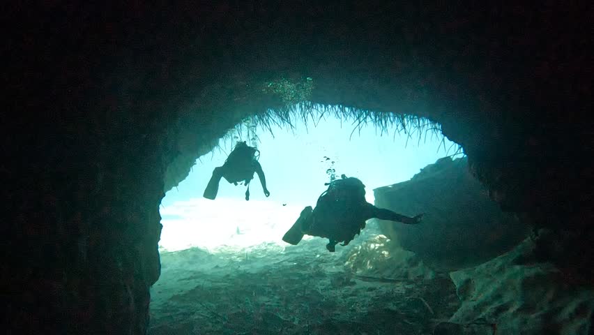 Divers Swimming Inside a Cave Underwater, Cenote in Cancun Mexico 
