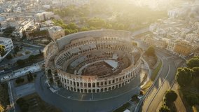 Morning glow over Colosseum - peaceful aerial view and lone car passing by, Rome - Powered by Shutterstock - Get 15% off with code: PIKWIZARD15