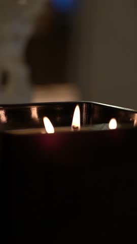 An interior scented candle with five wicks. Close-up of candle flame for background