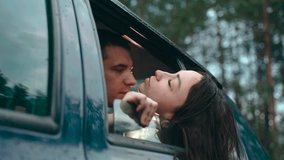 Amidst the serene embrace of nature, a couple leans in for a tender kiss from their car. Raindrops dance on the window, adding a magical touch to their romantic getaway. - Powered by Shutterstock - Get 15% off with code: PIKWIZARD15