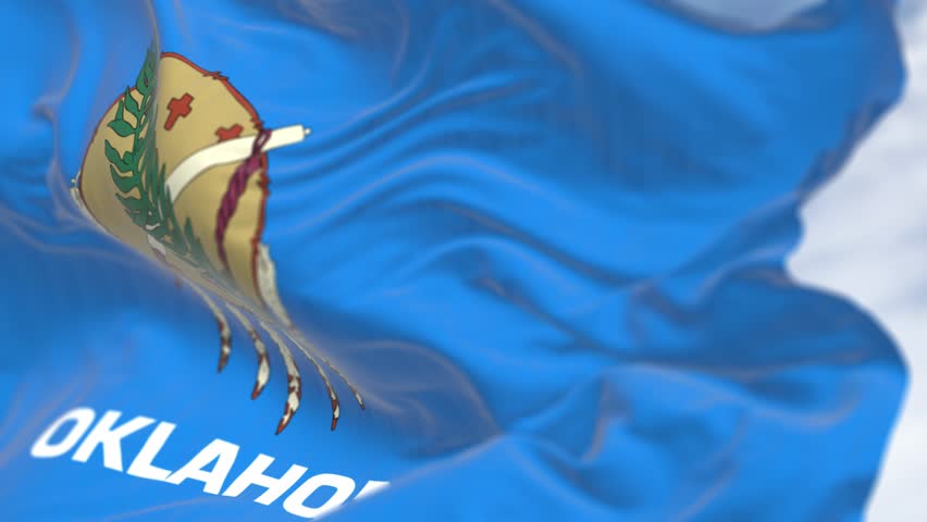 Close-up of Oklahoma state flag waving on a clear day. Oklahoma is a state in the South Central region of the United States. Seamless 3d render animation. Slow motion loop. Selective focus.