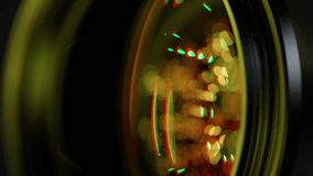 A close up of a camera lens with a yellow tint. The lens is focused on a blurry image, creating a sense of depth and movement. The yellow tint adds a warm, inviting atmosphere to the scene - Powered by Shutterstock - Get 15% off with code: PIKWIZARD15