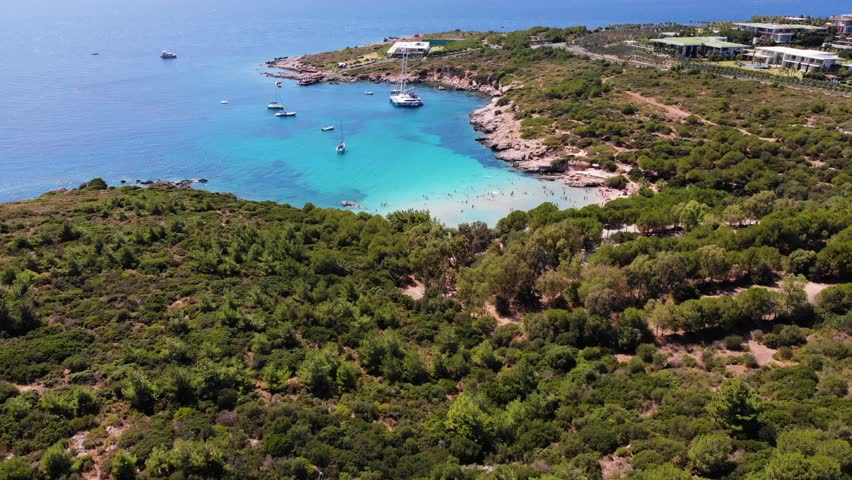 People swimming in the sea and sunbathing on the beach on the Turkish coast - Turkey