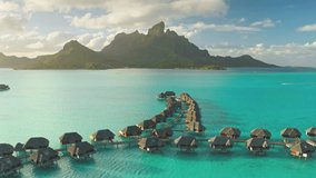 Aerial view of amazing overwater bungalows in Bora Bora, with mount Otemanu in the background, creating a tropical paradise scene. Wild travel destination, remote nature paradise, exotic summer view - Powered by Shutterstock - Get 15% off with code: PIKWIZARD15