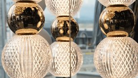 Close-up of elegant crystal and golden decorative elements reflecting light. Intricate diamond patterns and smooth surfaces in a modern interior setting. - Powered by Shutterstock - Get 15% off with code: PIKWIZARD15