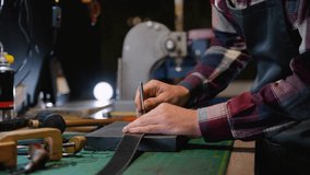 Leather Craftsman Punching Holes in a Belt with Precision - Powered by Shutterstock - Get 15% off with code: PIKWIZARD15