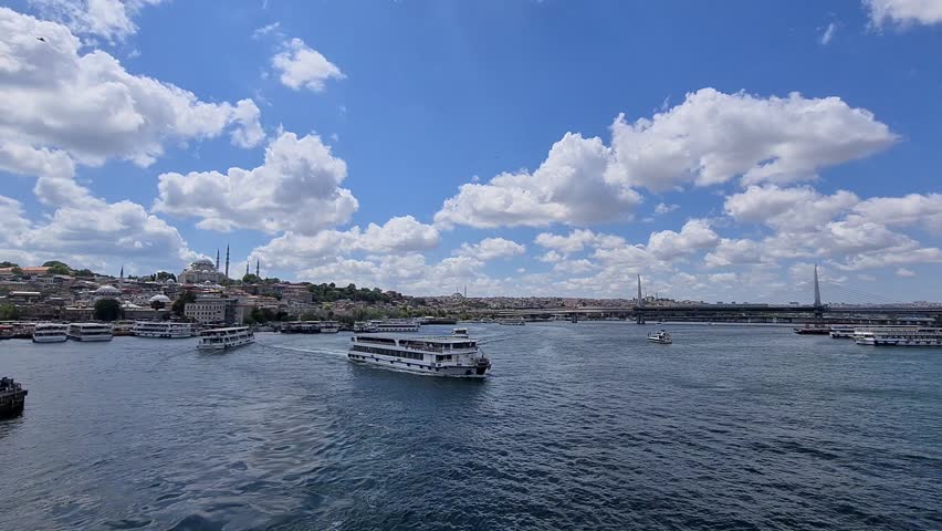 Istanbul, Turkey - July 22, 2021: Istanbul skyline. Amazing view of the Galata Tower and the Galata Bridge. Speedboats are crossing the Golden Horn. Istanbul is a popular tourist destination.
