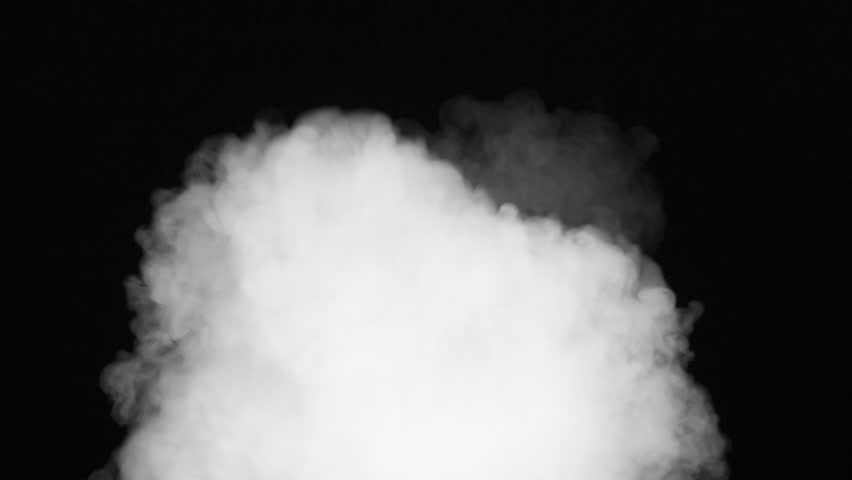 Powerful Explosion of Steam. A stream of white smoke emerges from the darkness and moves straight into the camera, completely filling the screen with a white veil