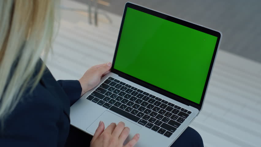 Freelancer browsing greenscreen laptop app at remote workplace closeup. Unknown businesswoman working on chroma key computer in office space. Blonde woman developing online project at mockup pc device