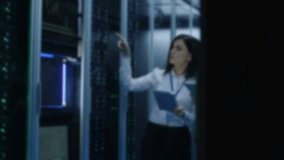 Women analyzing data in server room. Two women in professional attire reviewing data on tablets inside a modern server room with blue-toned lighting. - Powered by Shutterstock - Get 15% off with code: PIKWIZARD15