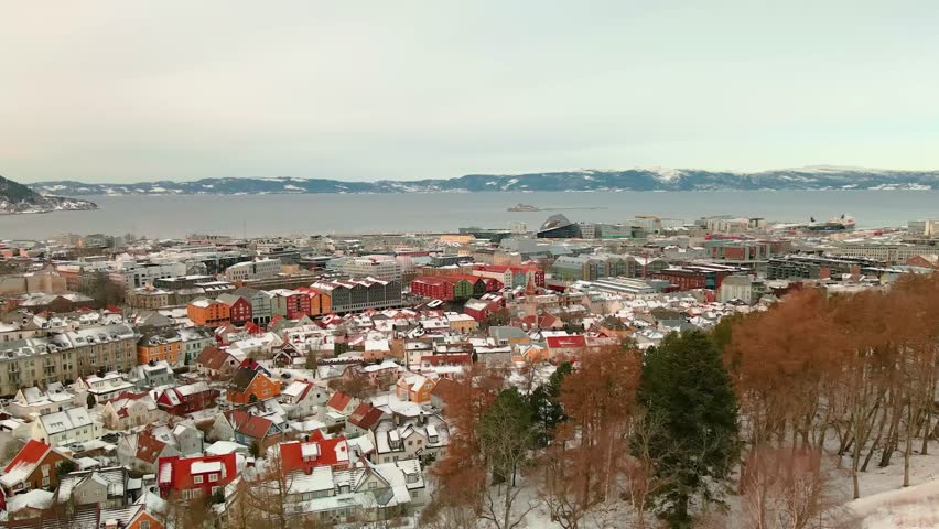 Trondheim, Norway. Aerial view of the city center in winter in Trondheim, Norway with snow, river and historical colorful buildings.