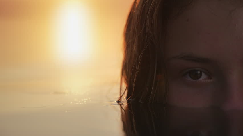 Half-Submerged Gaze in Sunset Glow