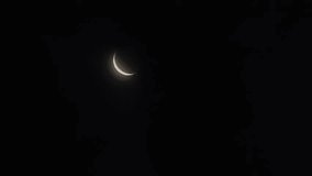 Crescent moon with earthshine being covered by moving clouds at dawn
 - Powered by Shutterstock - Get 15% off with code: PIKWIZARD15