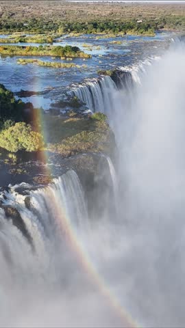 Victoria Falls At Livingstone Northern Rhodesia Zambia. Breathtaking Aerial Footage Of Waterfalls As Natural Wonder. Nature Sky Clouds Mountain Canyon. Nature Outside Waterfall Panoramic View.
