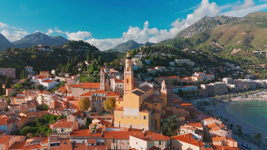 Aerial view of Menton, a resort town on the French Riviera, France. The colourful old town of Menton in summer, with historic buildings and beautiful beach at sunset on the Cote dAzur.