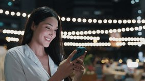 Happy Female Cafe Owner Replying In Work Chat Using Her Smartphone While Standing Outside. Beautiful, Positive Girl Texting On Her Phone And Smiling At The SMS. People and Technology - Powered by Shutterstock - Get 15% off with code: PIKWIZARD15
