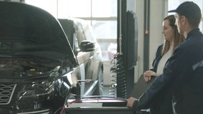 Female Manager Discussing Vehicle Repair with Mechanic in Auto Repair Shop - Powered by Shutterstock - Get 15% off with code: PIKWIZARD15