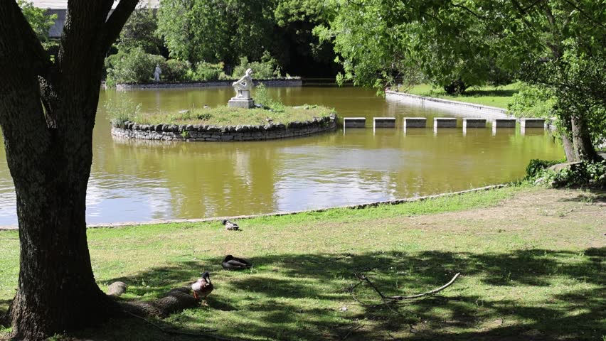 A Scenic view of a small lake at Parque Eduardo VII park in Lisbon, Portugal