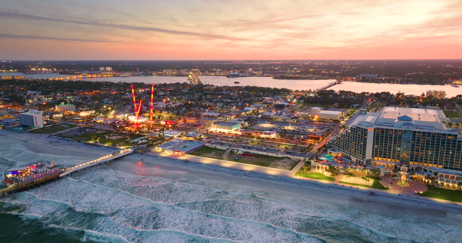 Daytona Beach, Florida. Tourist attractions and infrastructure at sunset. Main Street Pier and Breakers Oceanfront Park with amusement fairground.