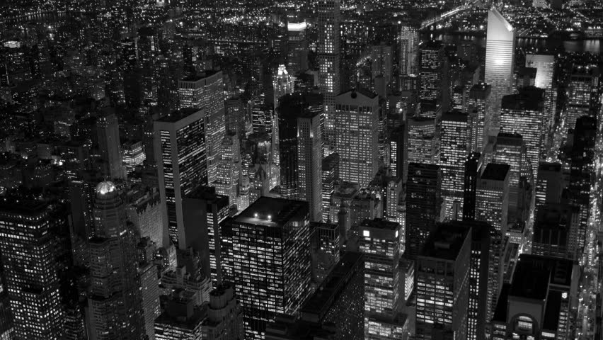 A stunning aerial night view of a vibrant urban cityscape in striking black and white