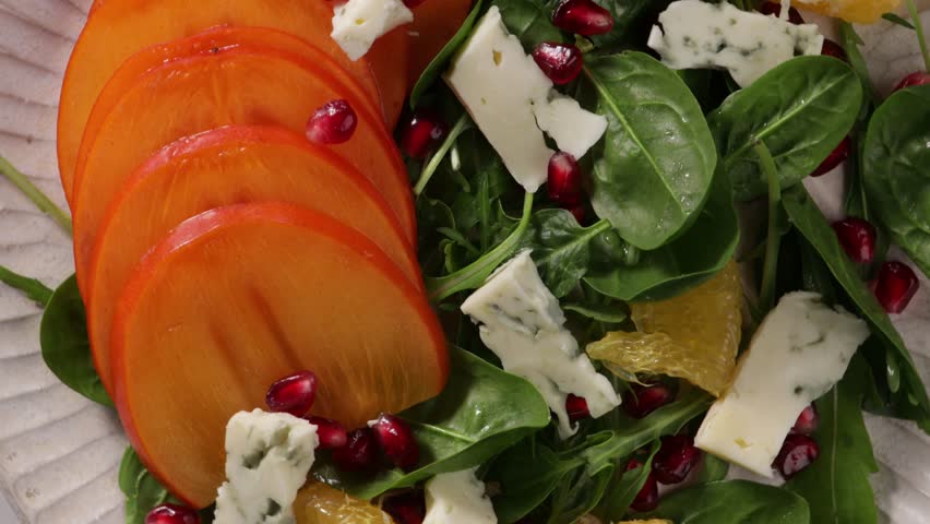 top view of persimmon salad with orange and cheese food rotation