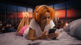 Young woman wears headphones, listening to music during a beautiful sunset - Powered by Shutterstock - Get 15% off with code: PIKWIZARD15