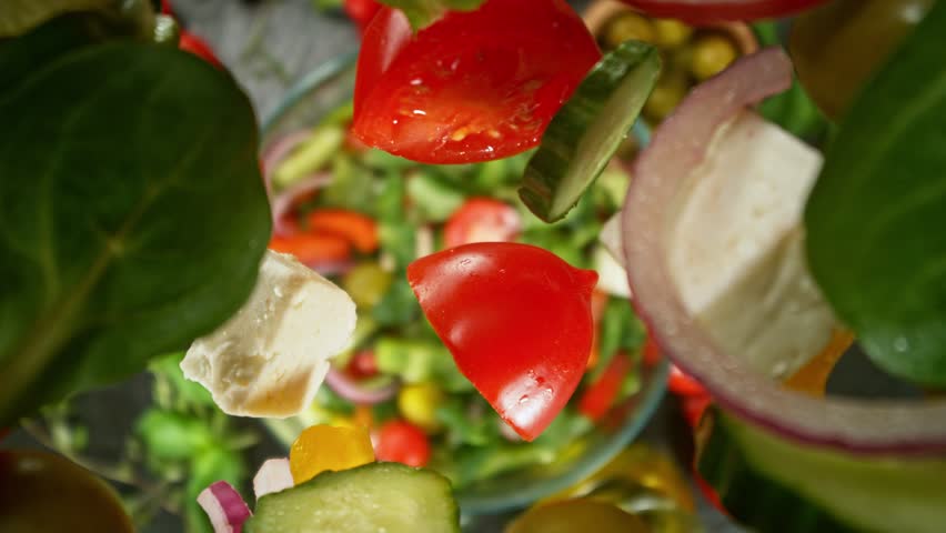 Super Slow Motion of Falling Salad Pieces into Bowl. Filmed on High Speed Cinema Camera, 1000 fps. Camera Tracking the Object.