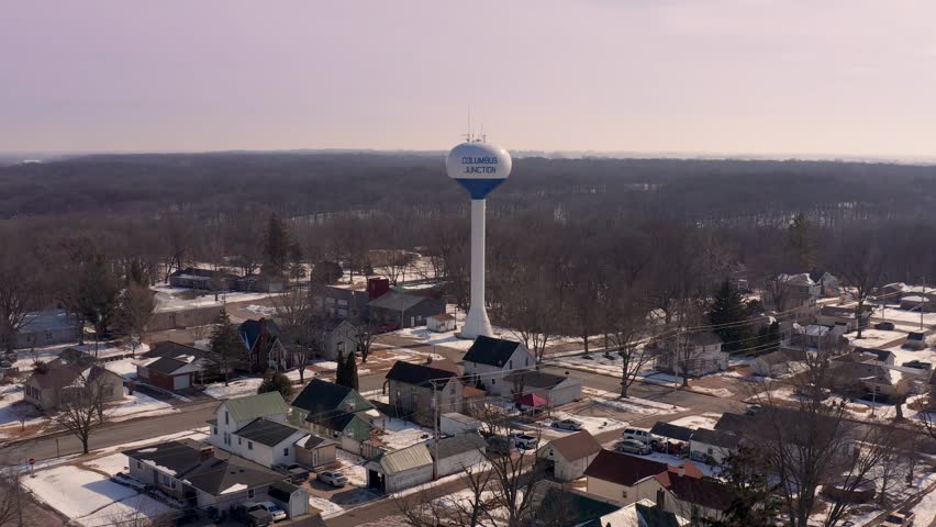 4K Aerial Footage of Columbus Junction Water Tower in a Serene Winter Landscape