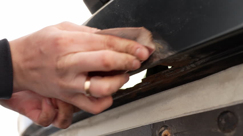 Car Rust Repair: Close Up of Mechanic Sanding Rusted Surface Before Painting