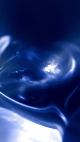 Vertical macro close up light blue water fluid background loop. Reflecting and transparent fluid shapes 3D animation backdrop. Microscopic organic moisture droplet. Clean purity and science backplate.