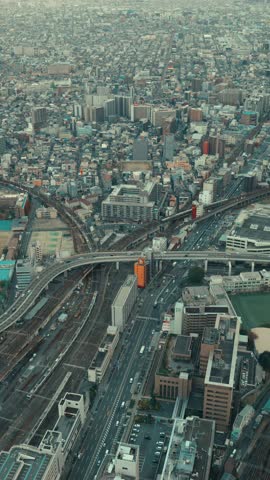 Top view of an Asian big city and many cars crossing, Abeno Harukas Observatory in Osaka in Japan, Travel or business, Vertical video for smartphone footage