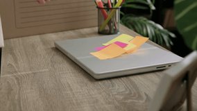 Close-up of a woman's hands packing up her personal belongings from an office to move to a larger, more comfortable one. Woman puts her work computer in the box with her personal belongings. - Powered by Shutterstock - Get 15% off with code: PIKWIZARD15