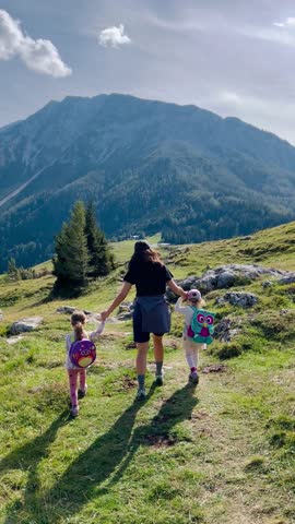 Family of mother and twins during a sunny day hiking trip in Rax, Schneeberg Sesselbahn chairlift funicular cable railway in mountains, Puchberg, Neunkirchen in Niederösterreich alps of Lower Austria 