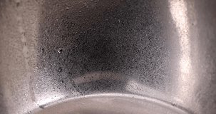 a shiny metal plate covered with water droplets, a piece of kitchen wetware in a large number of water droplets - Powered by Shutterstock - Get 15% off with code: PIKWIZARD15