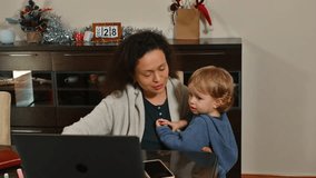Working Mother Holding Her Toddler at a Home Office Workspace - Powered by Shutterstock - Get 15% off with code: PIKWIZARD15