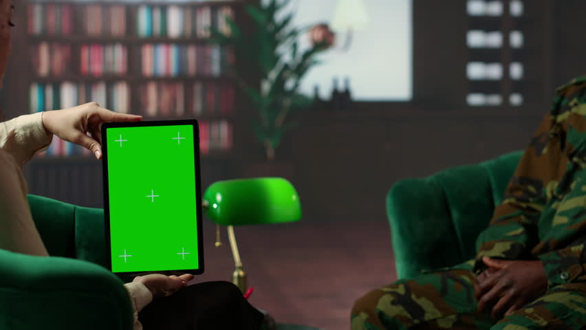 Black army soldier crying at therapy session next to chroma key screen, seeking professional support for PTSD and trauma recovery. Discussions for armed forces mental health care. Camera B.