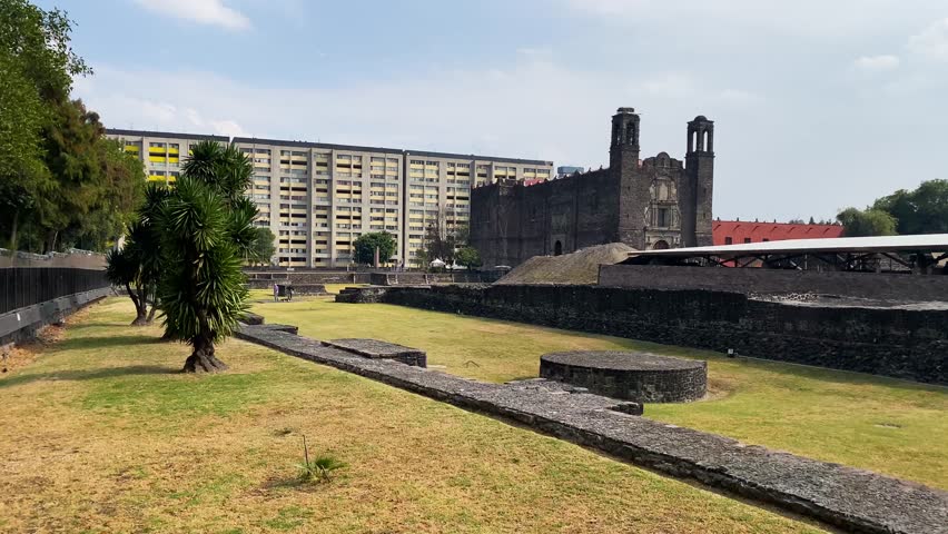 Ruins of Tlatelolco at Plaza de Las Tres Culturas, or Three Cultures square, backgrounded by the Temple of Santiago in Mexico City, Mexico.