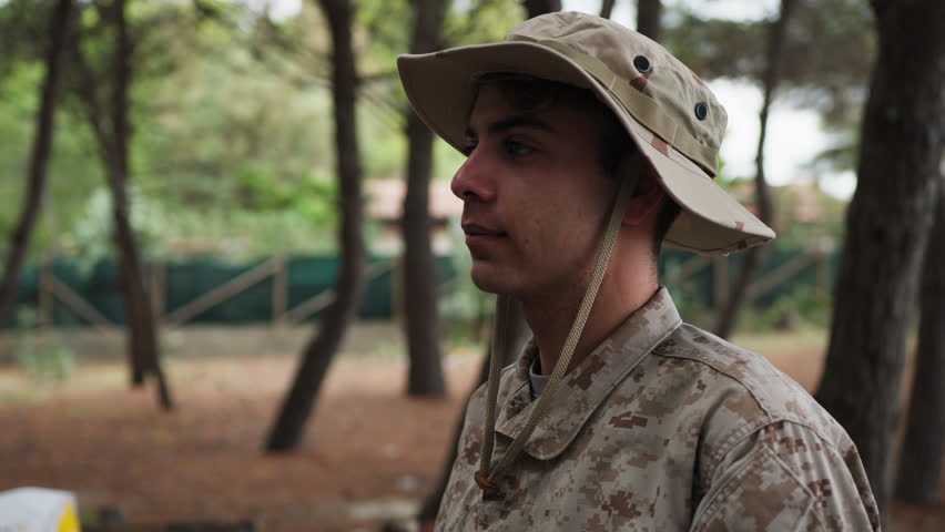 Soldier Stands At Attention Saluting The General In The Woods With Trees