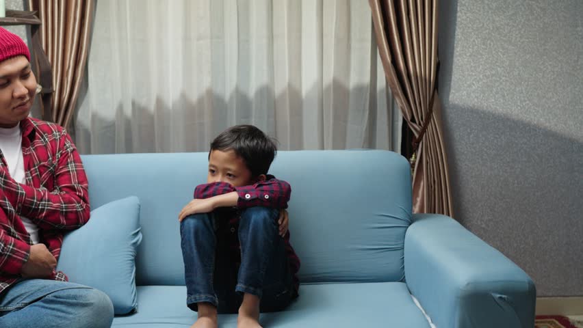 Happy boy receiving a surprise gift of a pet fish in a transparent plastic bag. A heartwarming moment of sibling love and joy. Pet fish, surprise gift, brotherhood, childhood, happiness