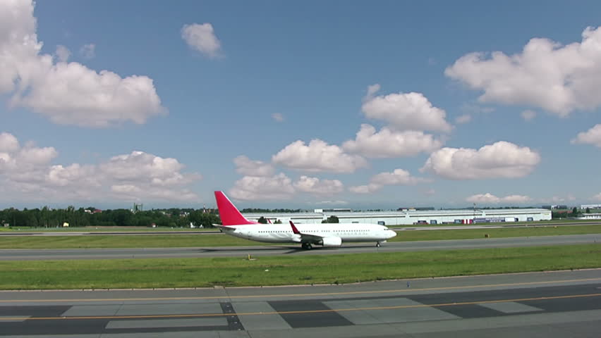 Airport. Summer. Sunny weather. One airplane going to the take off. The second