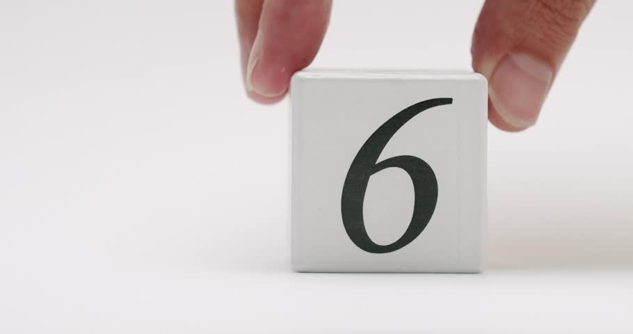 A minimalist white block featuring the number six, placed on a clean white background. Perfect for concepts related to counting, day six, or other number-related themes.