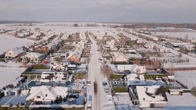 Aerial view of residential neighborhood with houses and road streets covered in snow. European small town at winter season - Powered by Shutterstock - Get 15% off with code: PIKWIZARD15