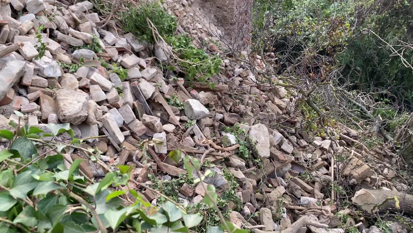 Castell'Arquato, PC, Italy - November 27th 2024 Debris and vegetation sliding down from a damaged brick house in town, due to a landslide and heavy rain - climate change
