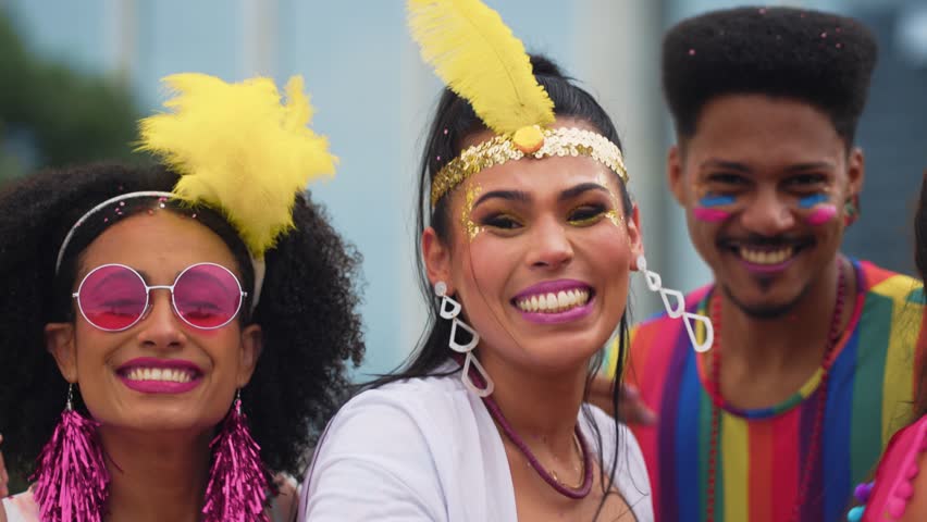 Smiling Friends Celebrating Brazilian Carnival in Colorful Costumes. Group of Joyful People Enjoying Vibrant Carnaval Street Party Outdoors in Festive Atmosphere