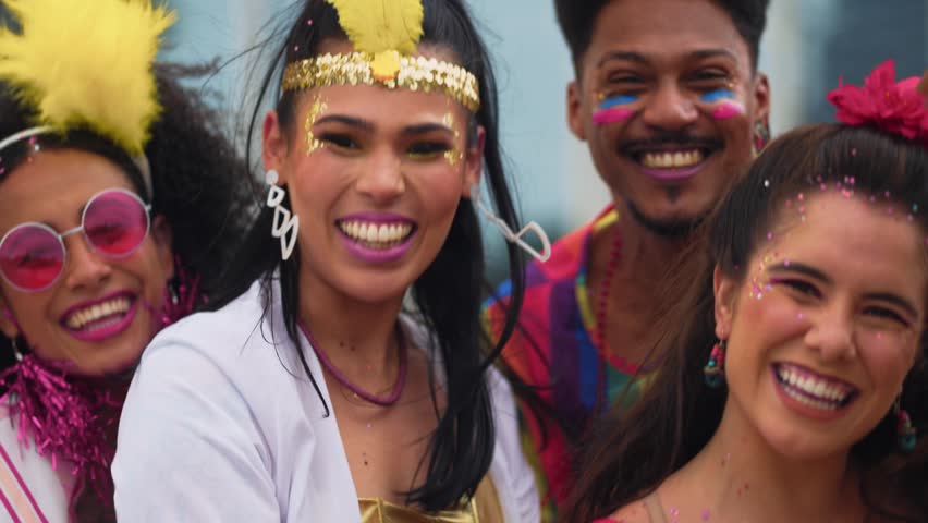 Smiling Friends Celebrating Brazilian Carnival in Colorful Costumes. Group of Joyful People Enjoying Vibrant Carnaval Street Party Outdoors in Festive Atmosphere