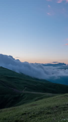 Mountains landscape and fast moving dramatic clouds at dawn, Caucasus, timelapse. Vertical video