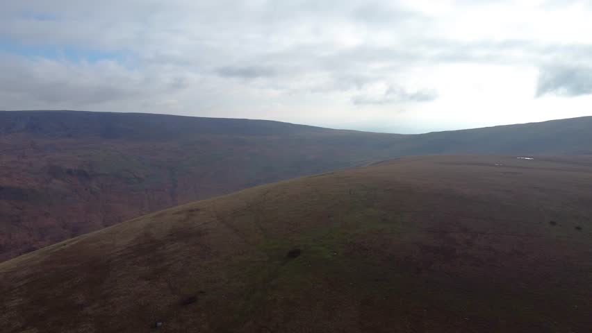 Aerial View of Brecon Beacons National Park with Hazy Atmosphere Mountain Landscape with Dipping Valleys 4K