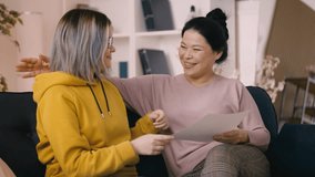 Teenage girl proudly shows her mom an A grade, celebrating academic achievements - Powered by Shutterstock - Get 15% off with code: PIKWIZARD15